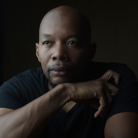 portrait of artist Marlon Griffith seated wearing black
