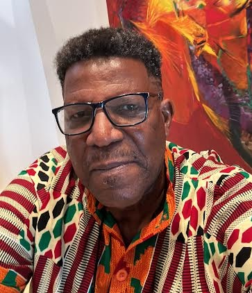 portrait of artist Ken Crichlow with colourful painting in background